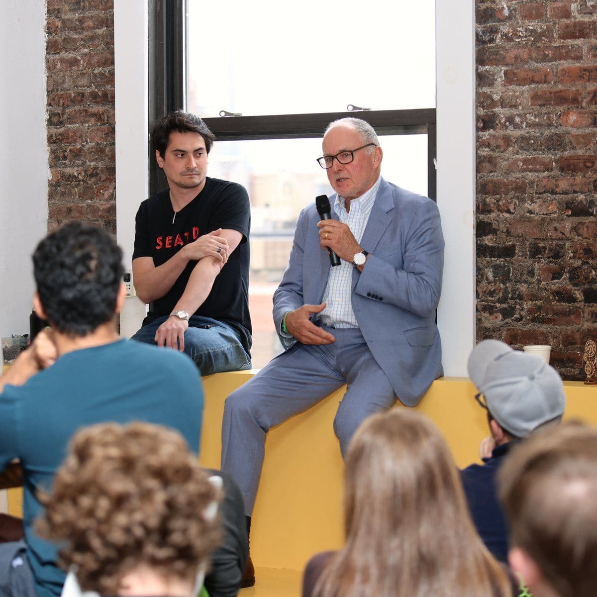Company leaders take questions from the team during an all-hands at the New York office