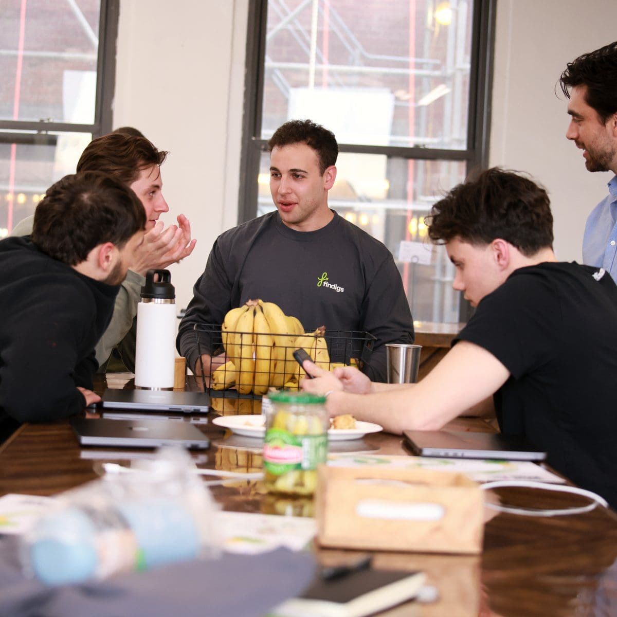 A teammate makes his case during a working session around the office table